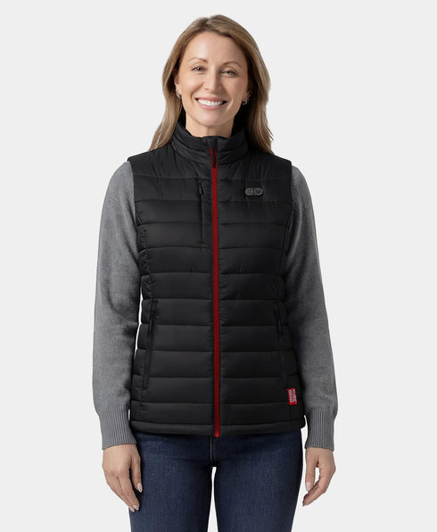 Woman wearing a black puffer vest with a red zipper on a white background ,view 1